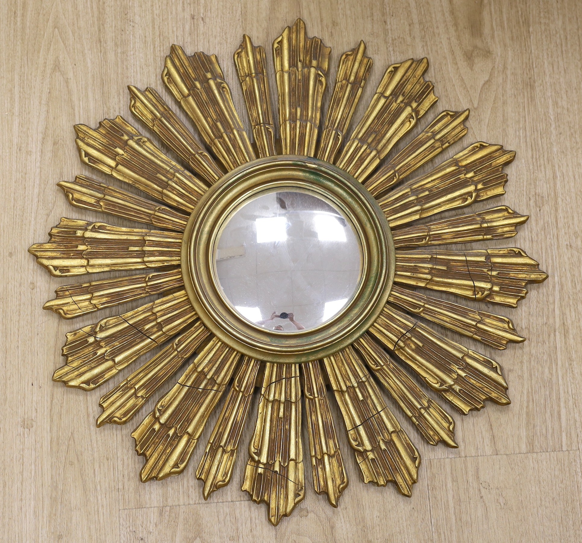A gilt wood sunburst convex wall mirror, 64cm